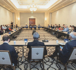 Healthcare executives seated in a U-shaped conference room arrangement at Health Evolution Summit 2026.
